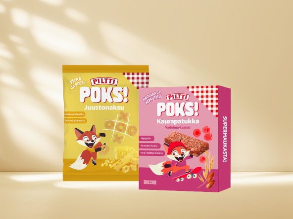Kaksi Piltti Poks! -tuotepakkausta rusehtavaa taustaa vasten.